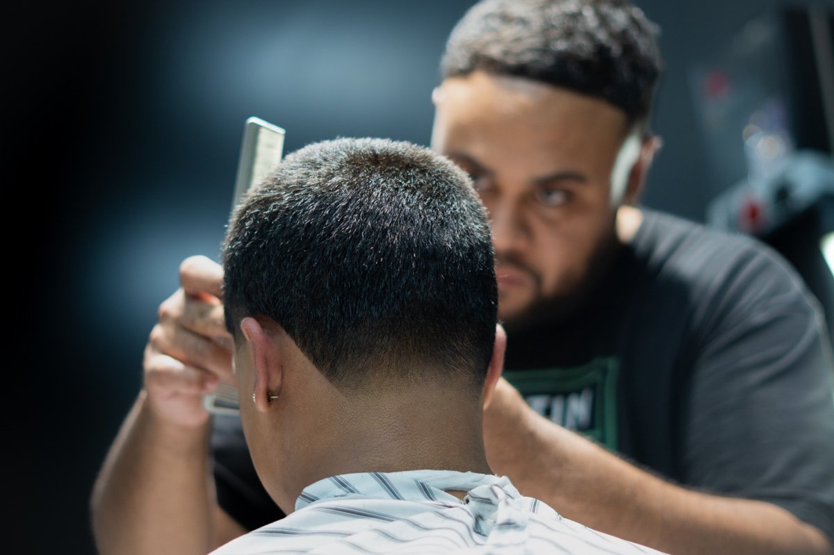 Devry cutting a client at Winners Circle Barbershop — South Austin